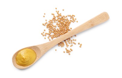 Fresh tasty mustard sauce in spoon and dry seeds isolated on white, top view