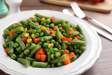 Mix of fresh vegetables served on  wooden table, closeup