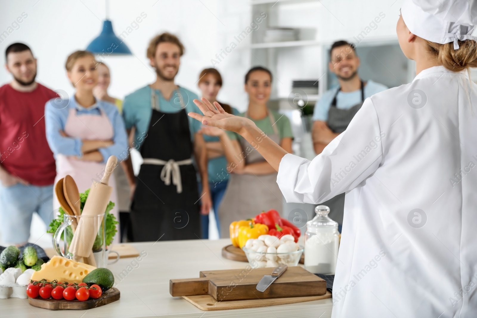 Photo of Group of people and female chef at cooking classes