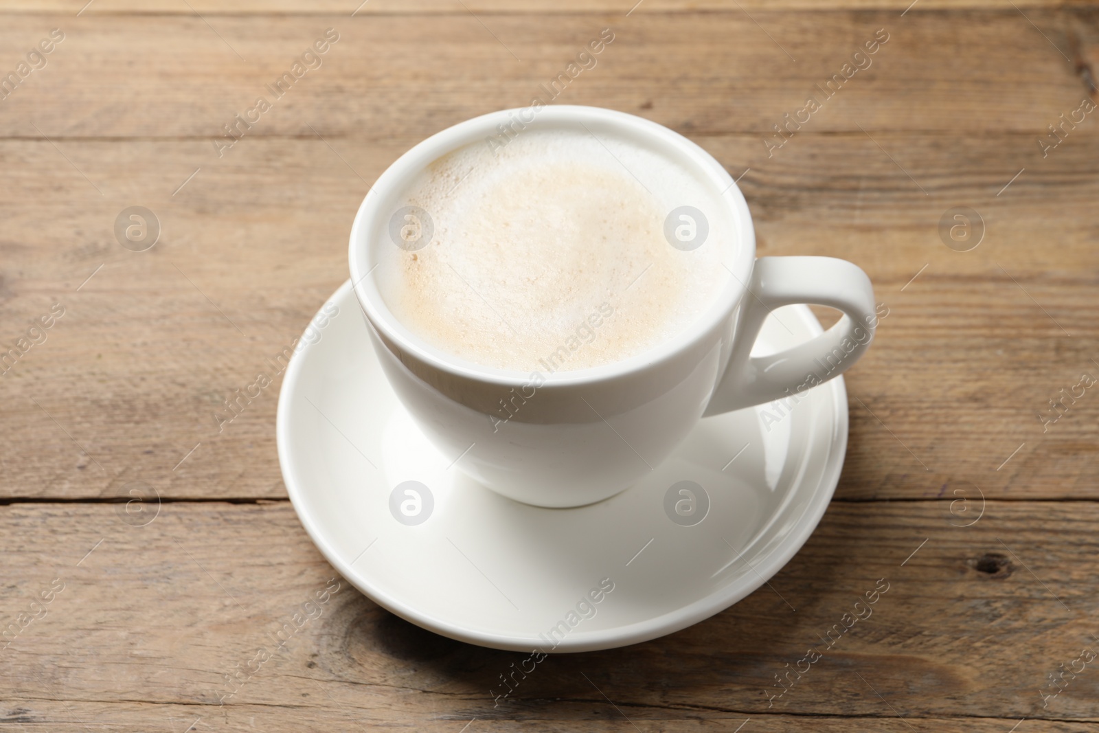 Photo of Cup of aromatic coffee on wooden table