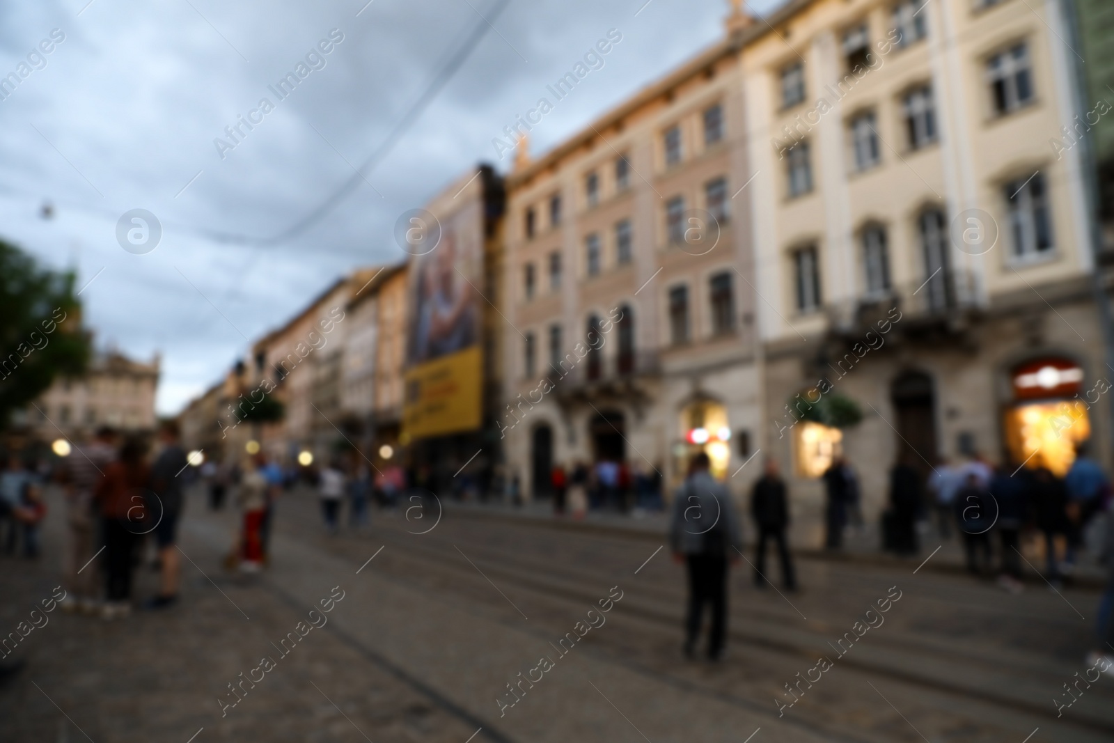 Photo of LVIV, UKRAINE - APRIL 27, 2019: People walking Market Square, blurred view