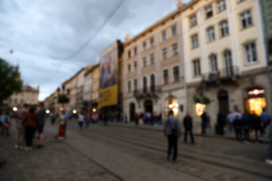 Photo of LVIV, UKRAINE - APRIL 27, 2019: People walking Market Square, blurred view