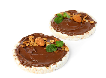 Photo of Puffed rice cakes with chocolate spread, nuts and mint isolated on white