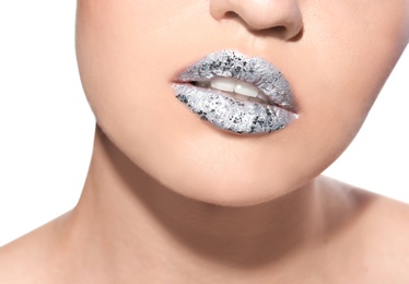 Photo of Beautiful young model with silver lips makeup on white background