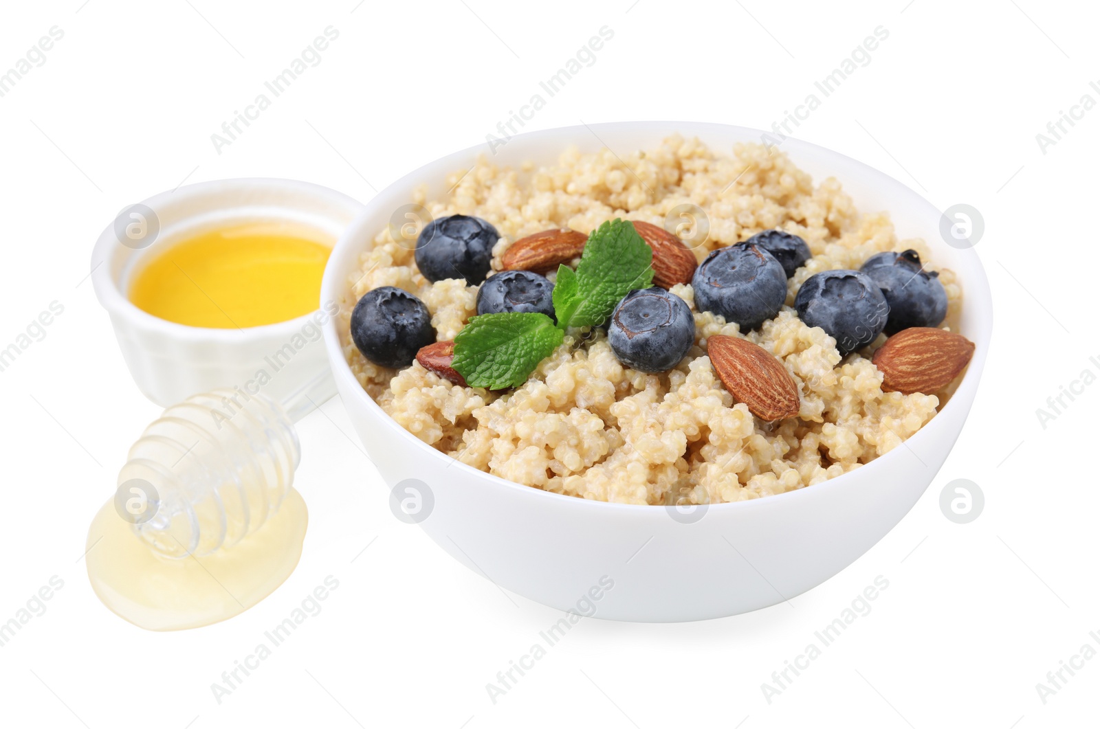 Photo of Bowl of delicious cooked quinoa with almonds, honey and blueberries on white background