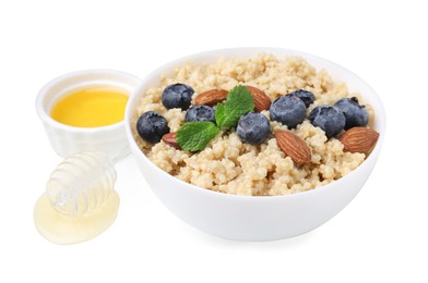Bowl of delicious cooked quinoa with almonds, honey and blueberries on white background