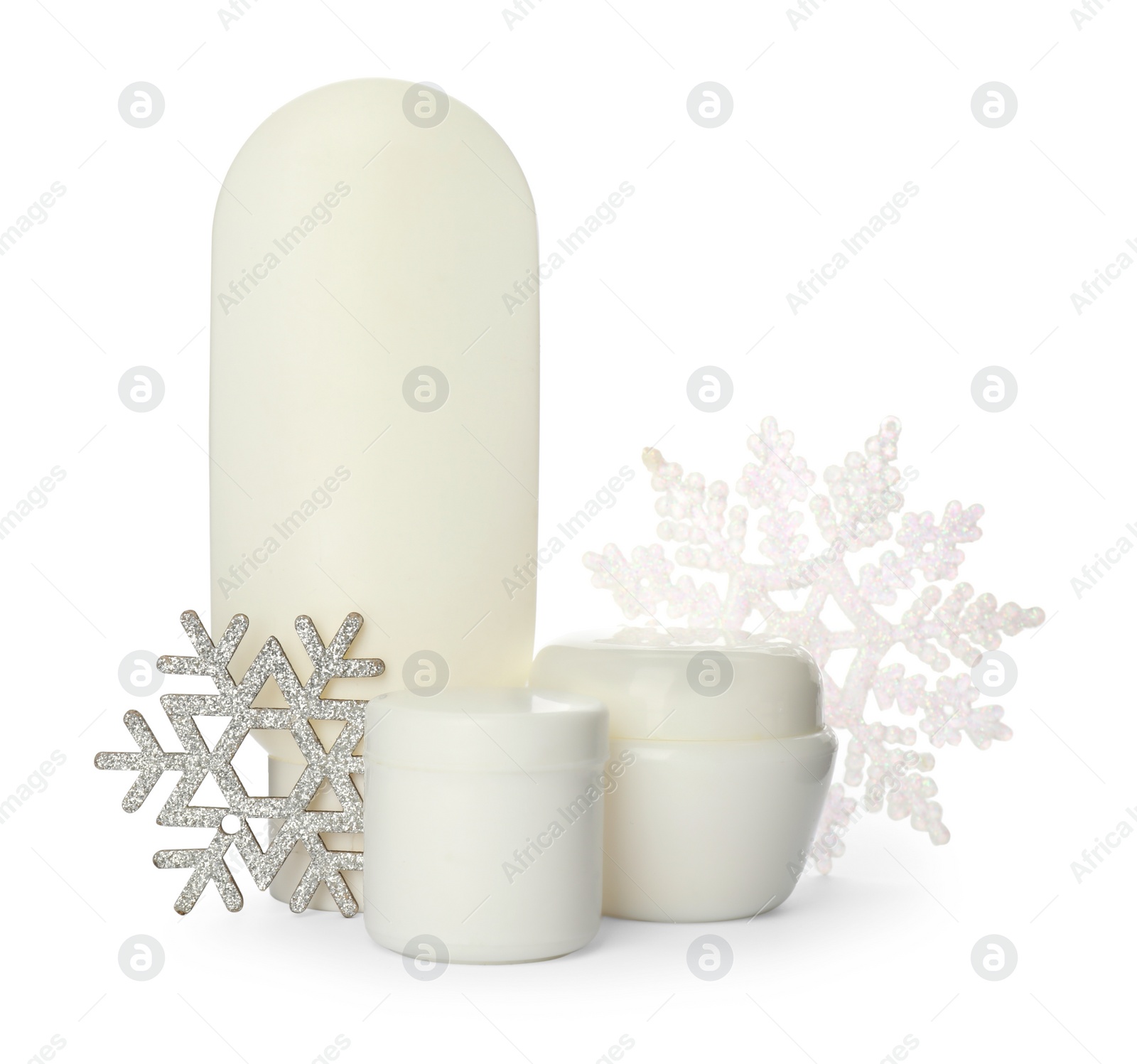 Photo of Set of cosmetic products and snowflakes on white background. Winter skin care