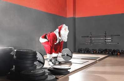 Photo of Young Santa Claus training in modern gym