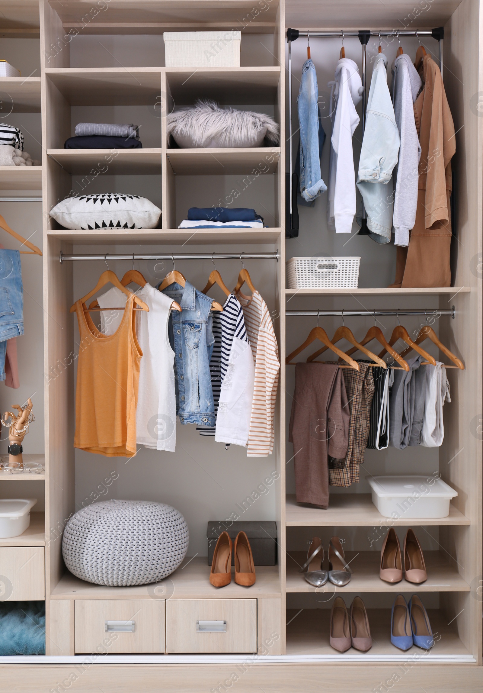 Photo of Stylish clothes, shoes and home stuff in large wardrobe closet