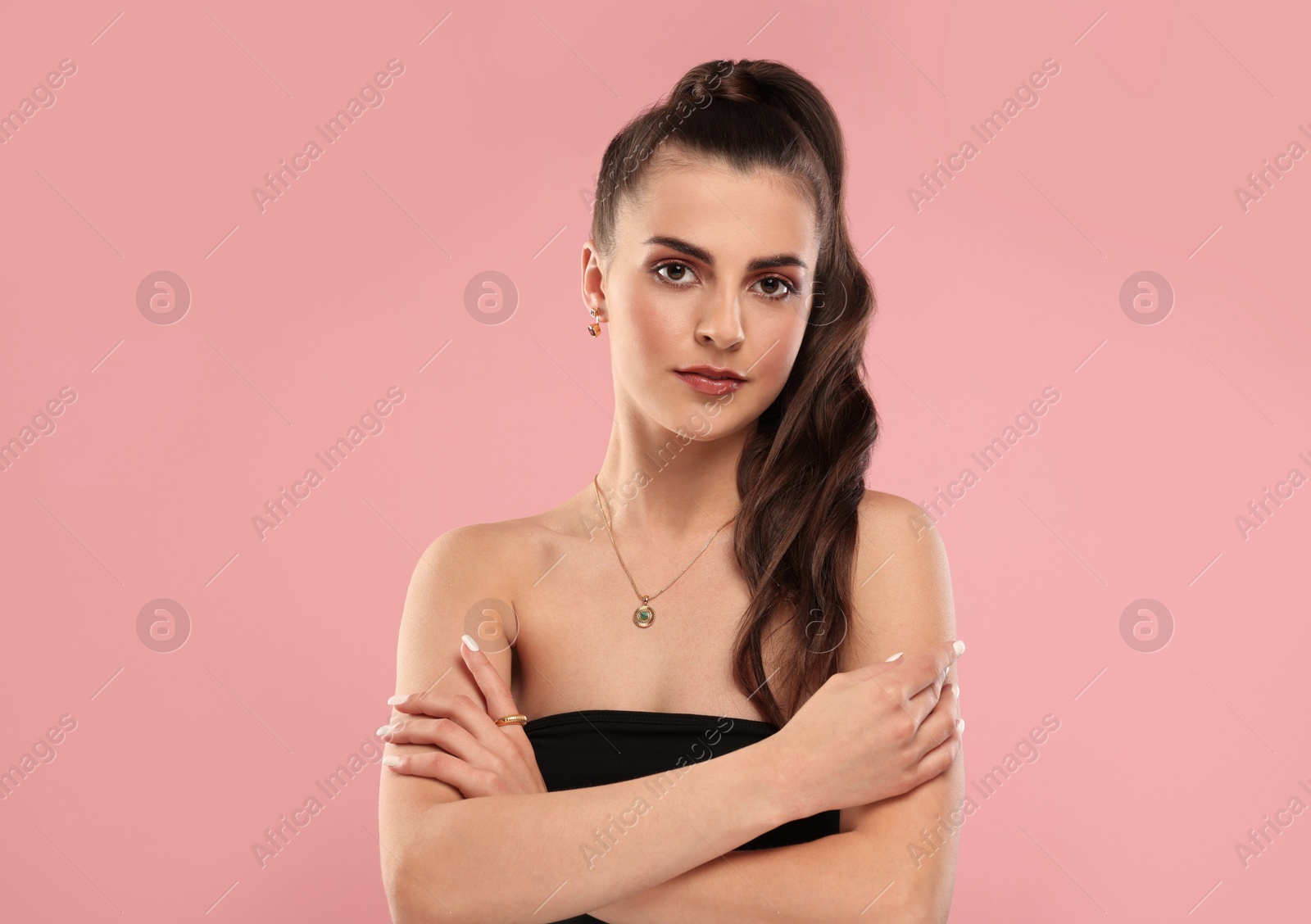 Photo of Beautiful woman with elegant jewelry on pink background