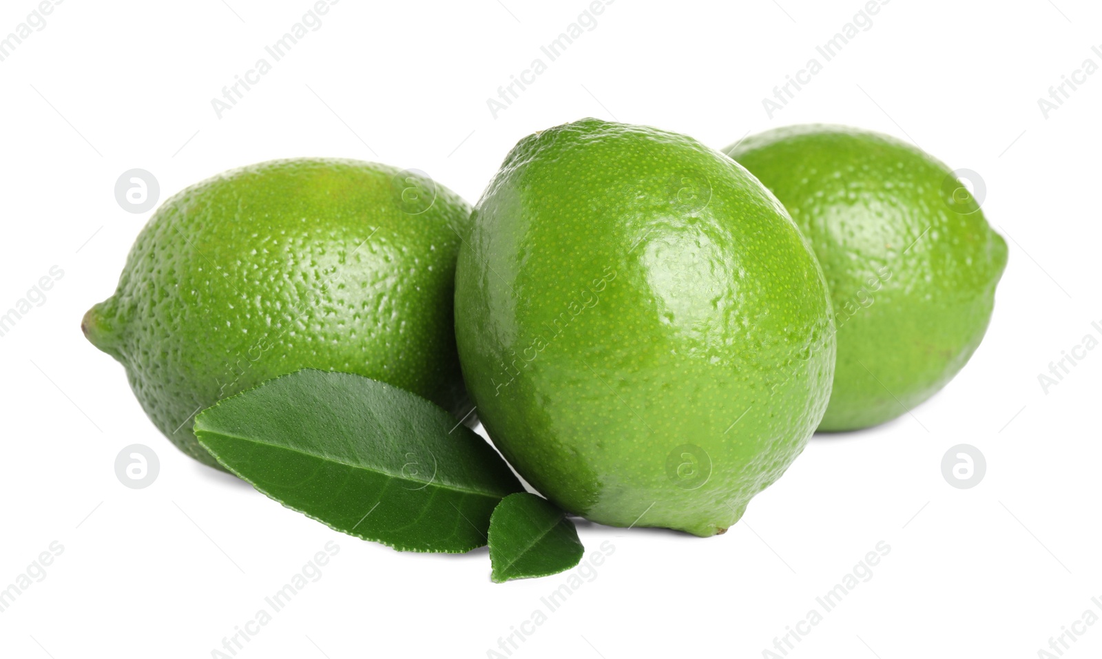 Photo of Fresh ripe limes with green leaves isolated on white