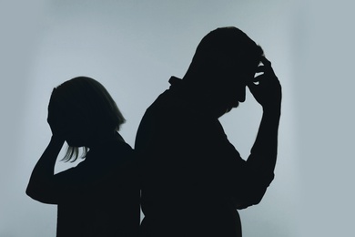 Photo of Silhouette of couple having argument on color background. Relationship problems