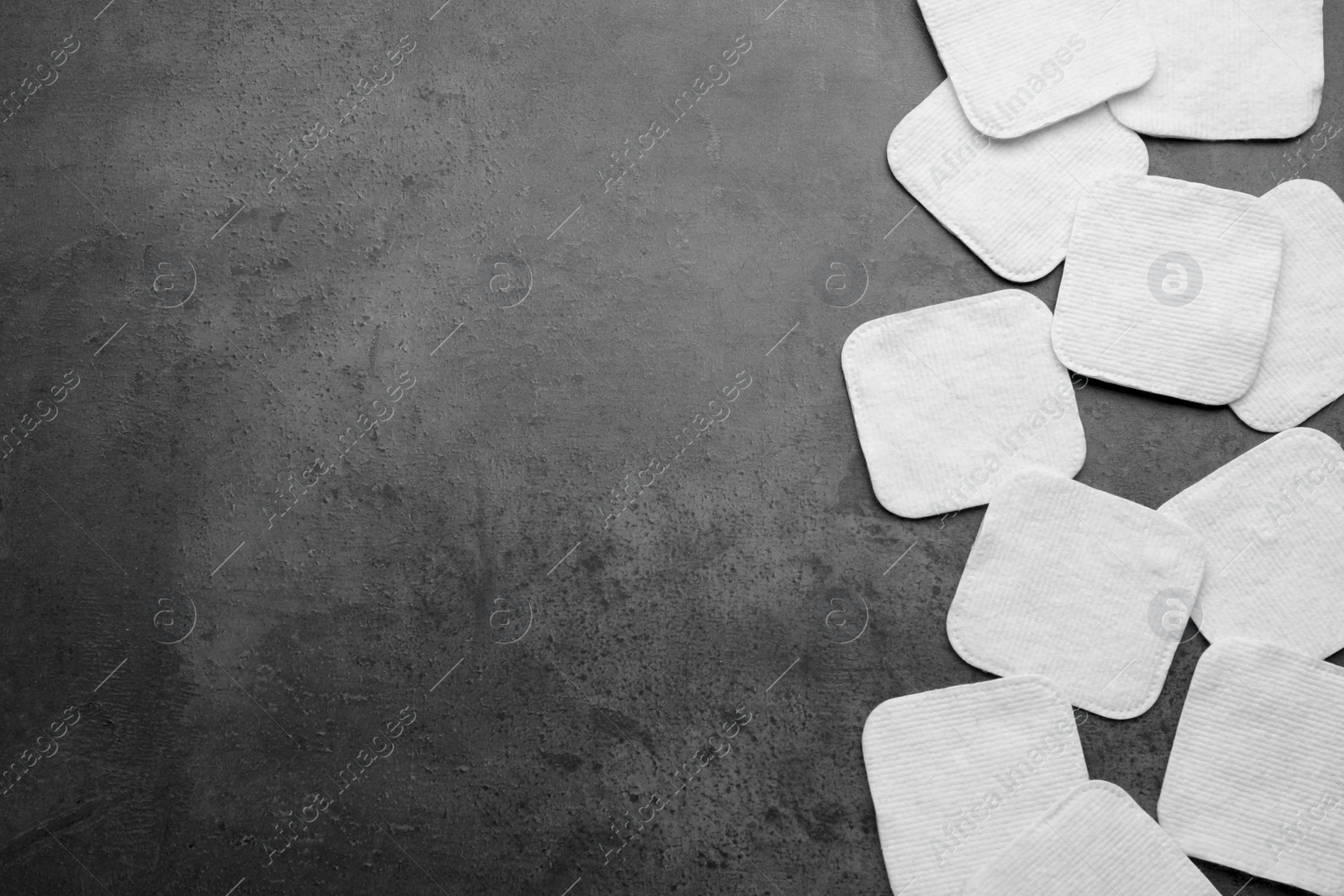 Photo of Many clean cotton pads on grey background, flat lay. Space for text