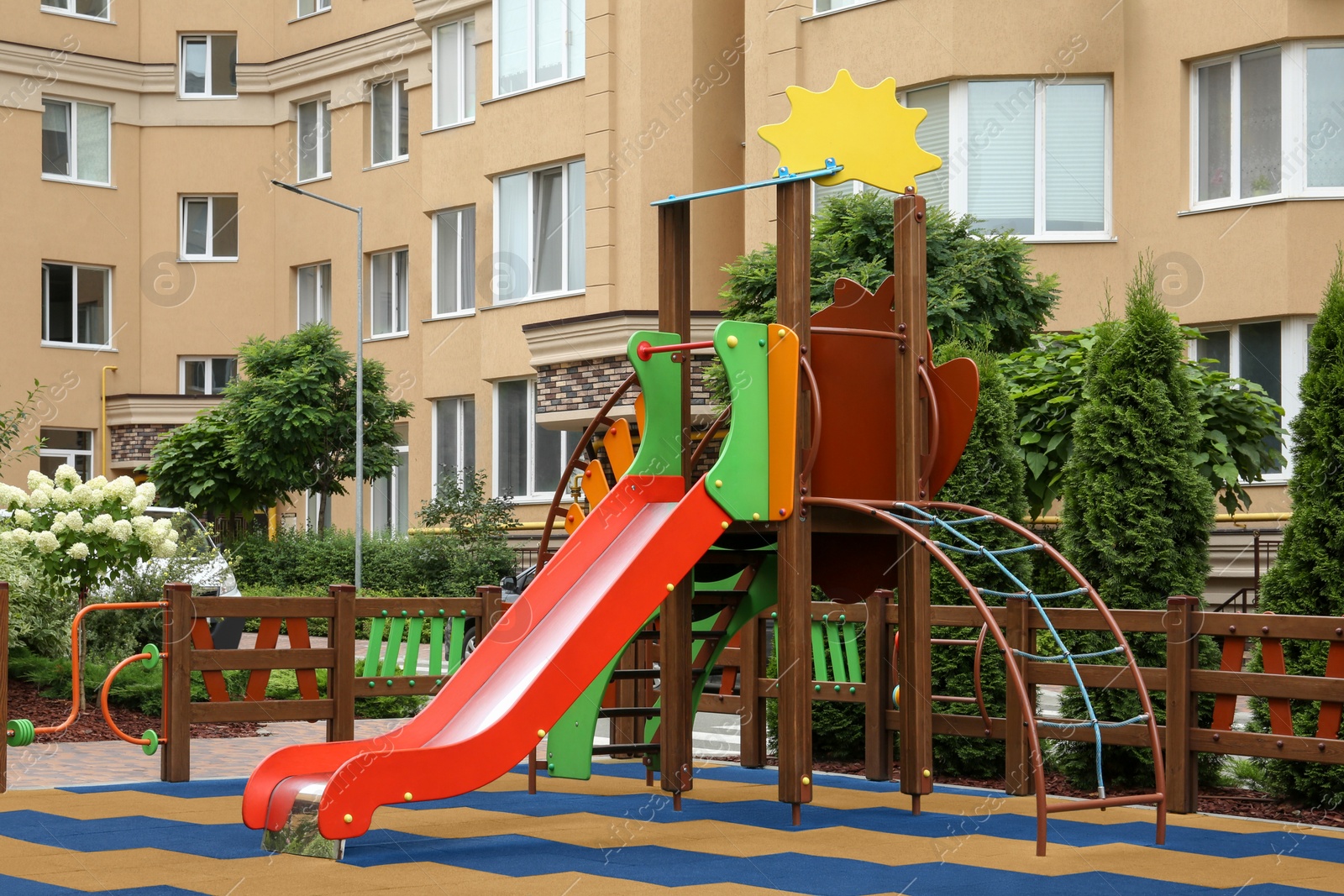 Photo of Empty outdoor children's playground with slide in residential area