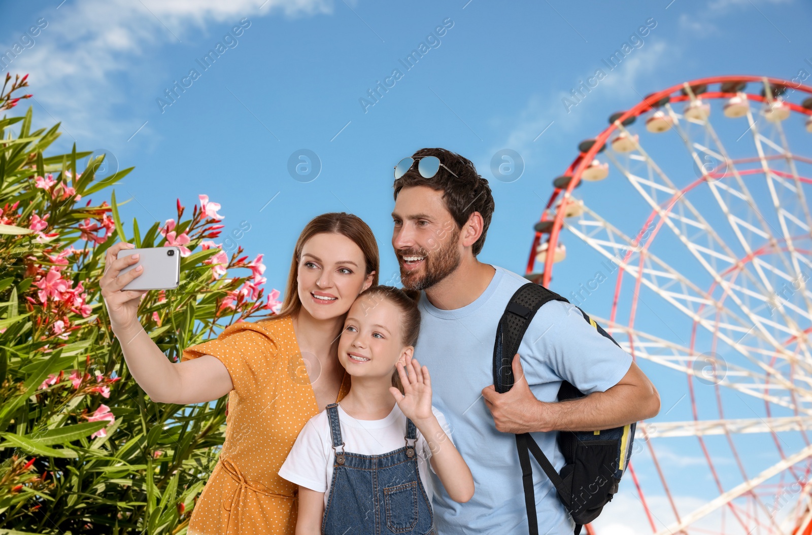 Image of Happy family with child taking selfie near observation wheel outdoors