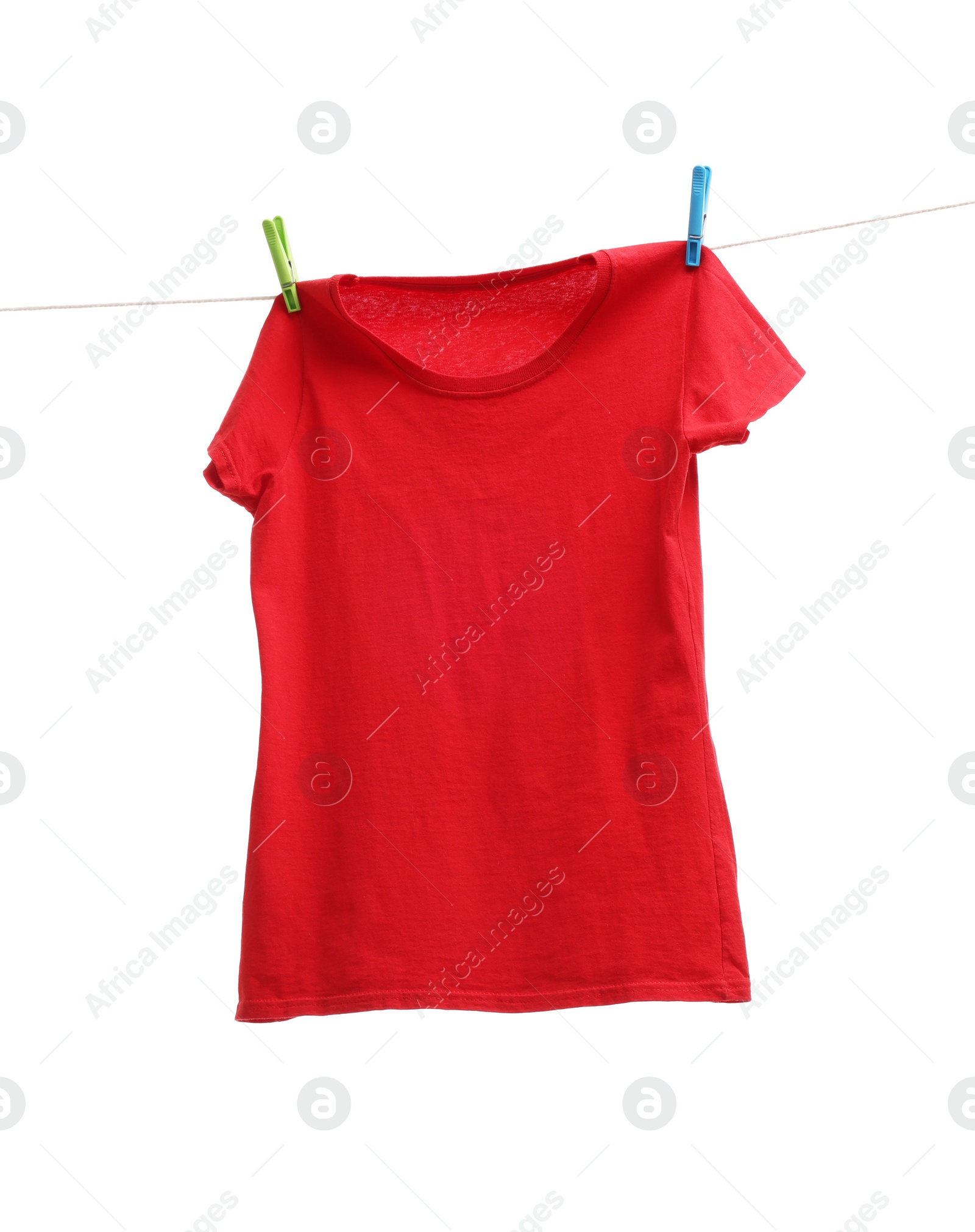 Photo of One red t-shirt drying on washing line isolated on white