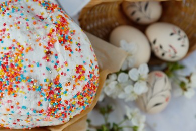 Photo of Kulich for Easter and eggs on cloth, above view