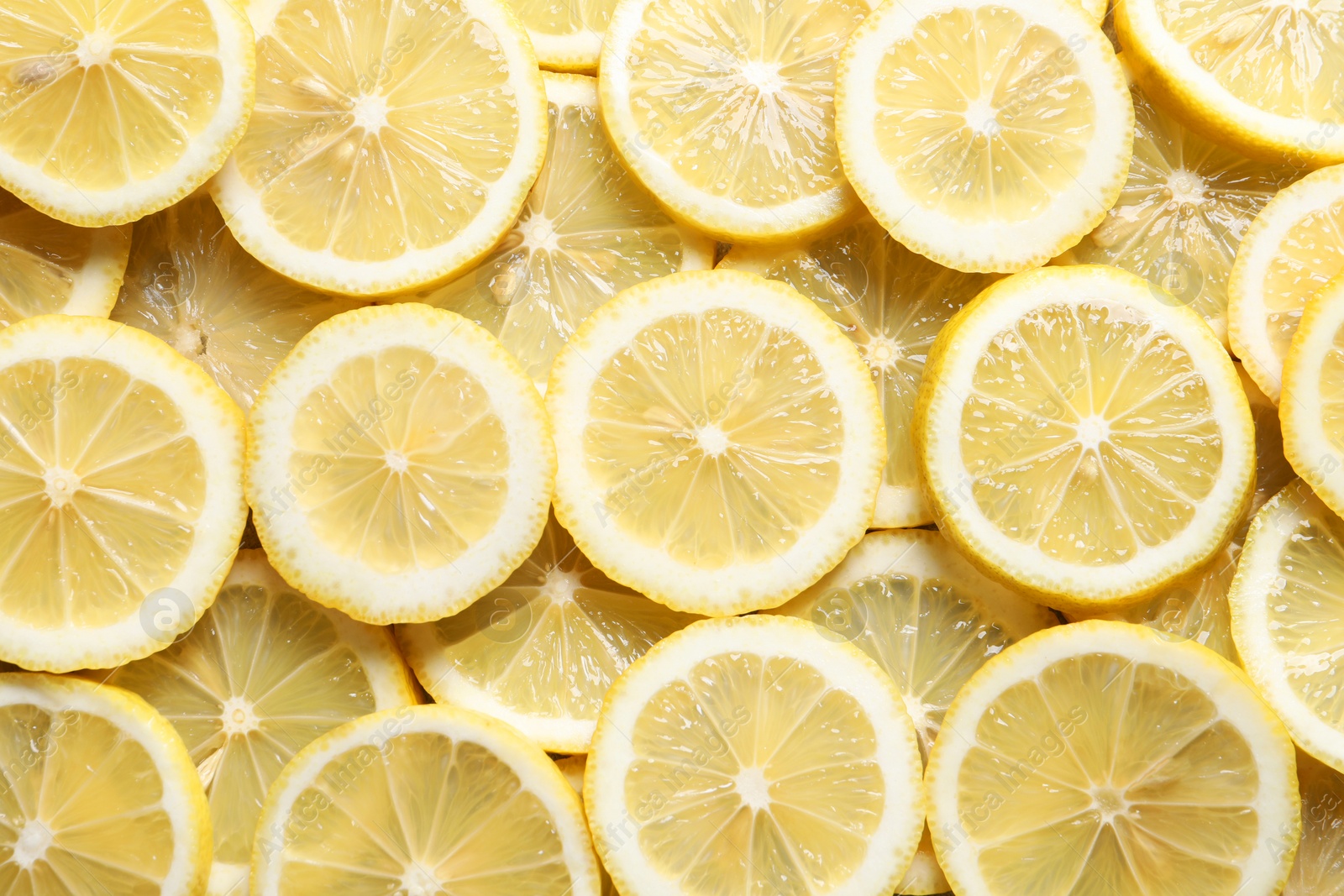 Photo of Slices of fresh lemons as background, top view