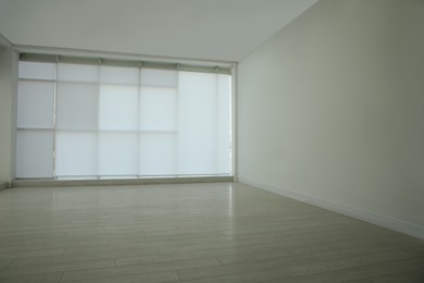 Photo of Empty room with panoramic windows and white wooden floor