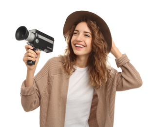 Beautiful young woman with vintage video camera on white background