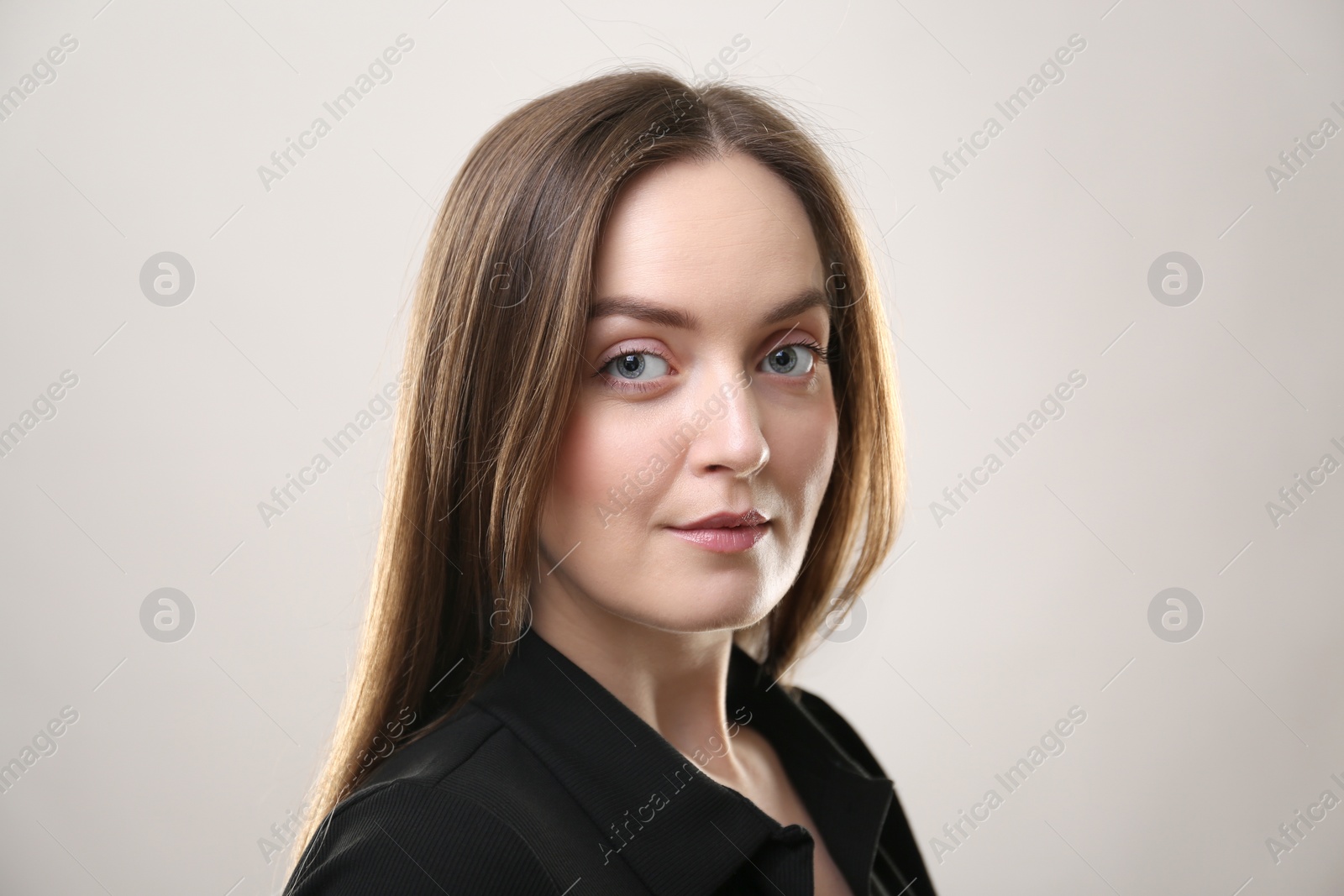 Photo of Portrait of beautiful young woman on beige background. Space for text