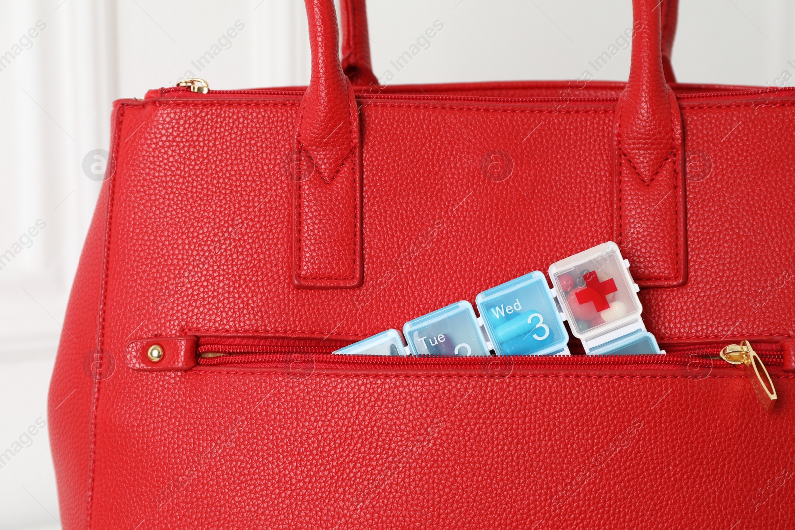 Photo of Pill box sticking out of bag indoors, closeup