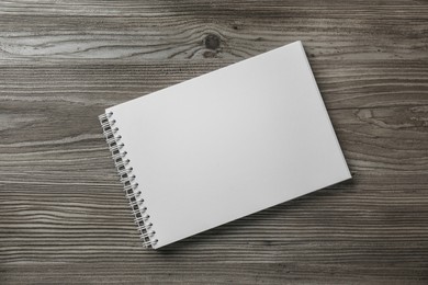 Blank paper brochure on wooden table, top view. Mockup for design