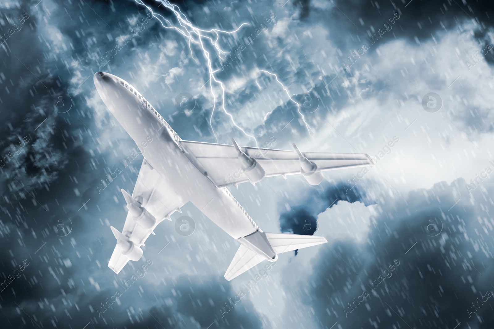 Image of Airplane flying in cloudy sky during thunderstorm