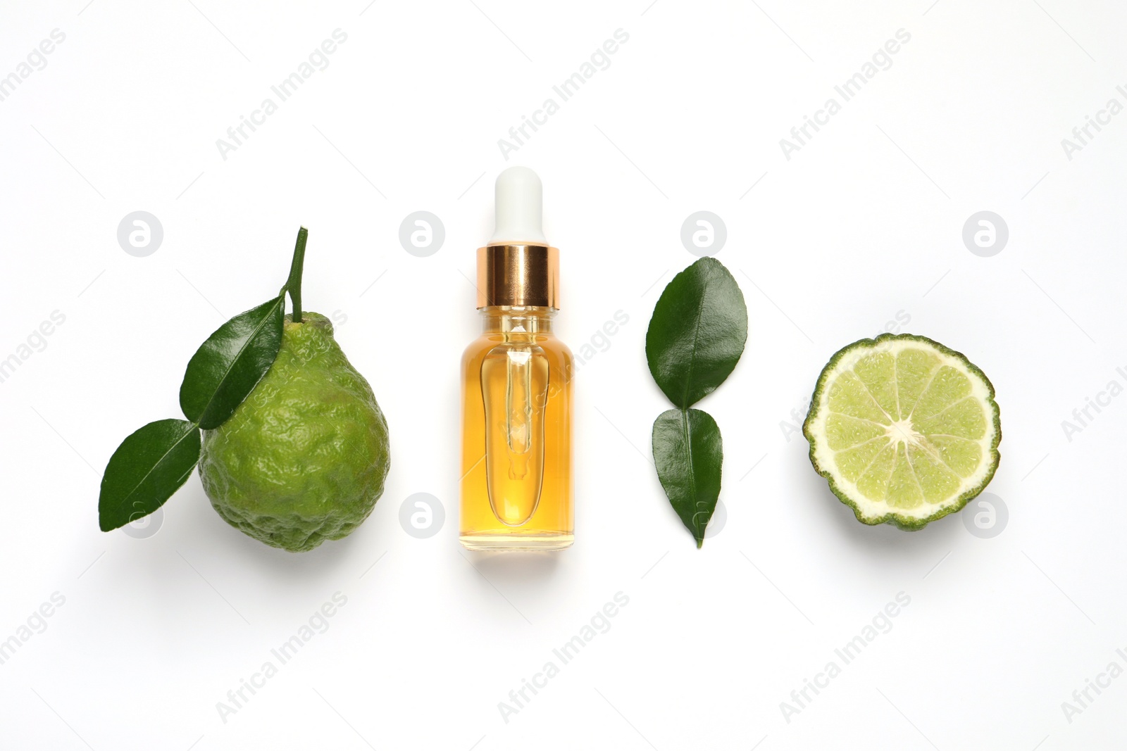 Photo of Glass bottle of bergamot essential oil and fresh fruits on white background, flat lay