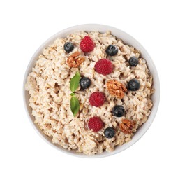 Photo of Tasty boiled oatmeal with berries and walnuts in bowl isolated on white, top view
