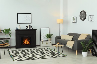Photo of Stylish living room interior with fireplace and comfortable sofa