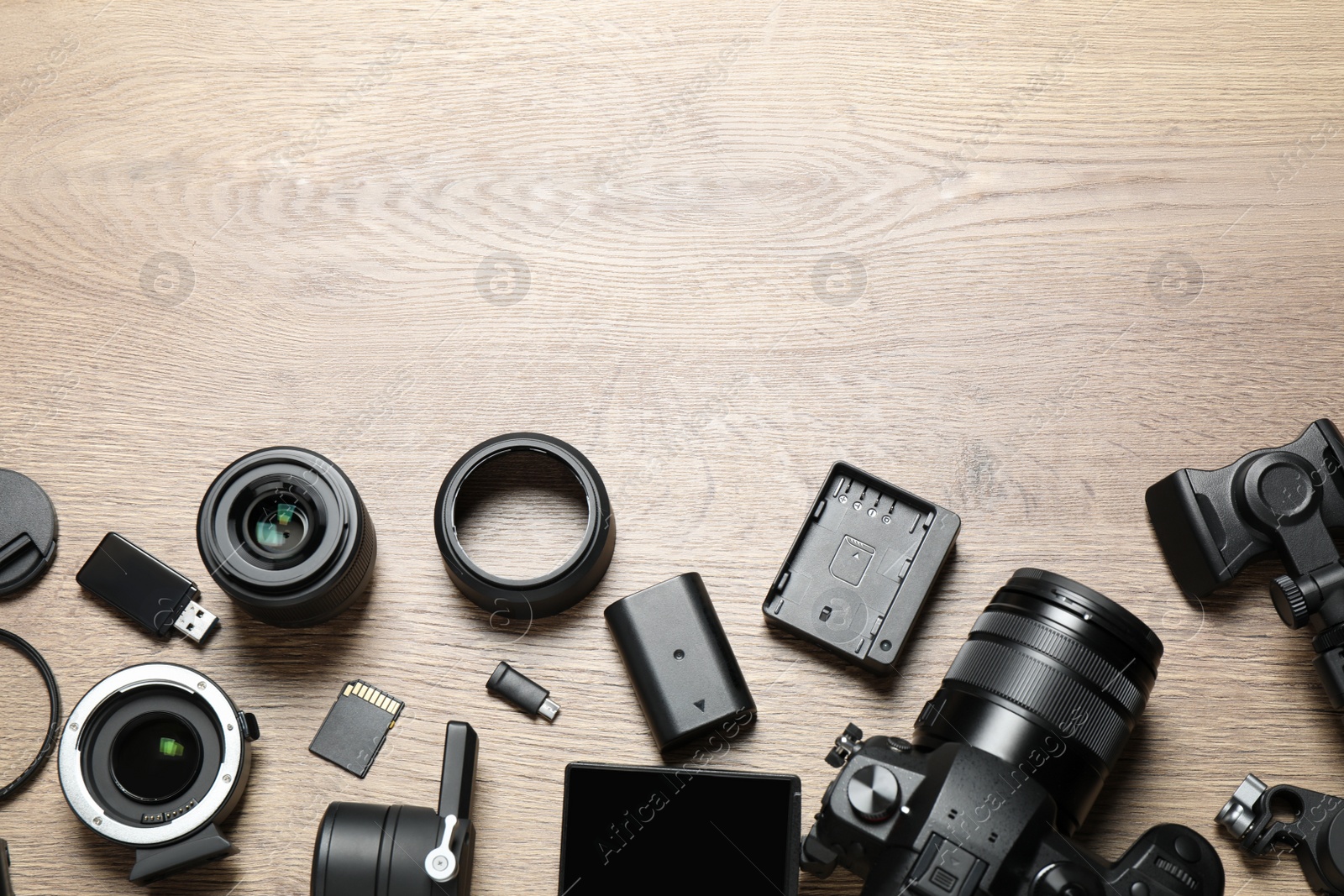 Photo of Flat lay composition with camera and video production equipment on wooden background. Space for text