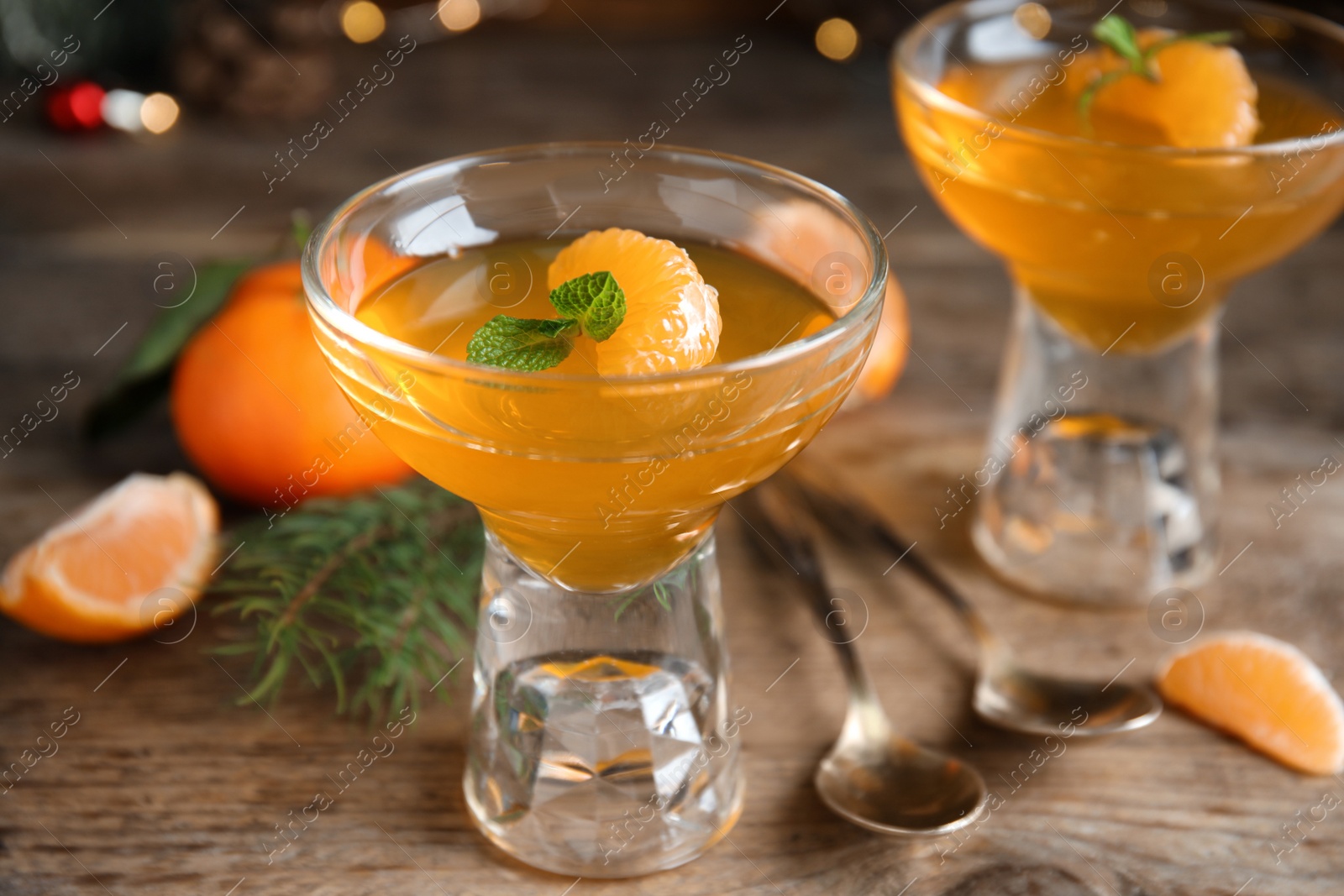 Photo of Delicious tangerine jelly on wooden table, closeup