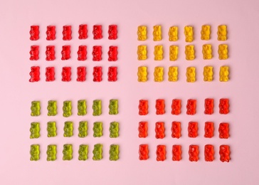 Photo of Flat lay composition with delicious jelly bears on color background