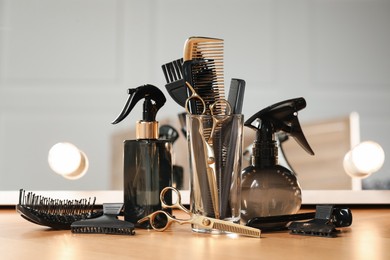 Photo of Set of hairdresser tools on table in salon