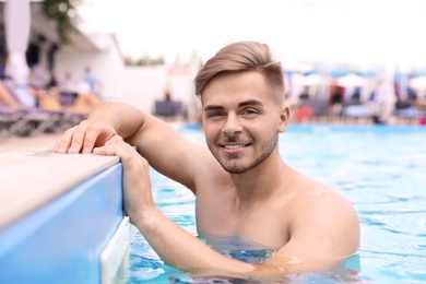 Young man in pool on sunny day