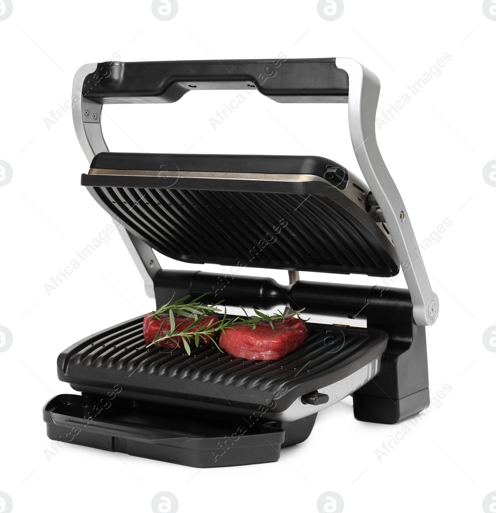 Photo of Electric grill with raw meat steaks and rosemary isolated on white