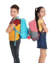 Little school children with backpacks on white background