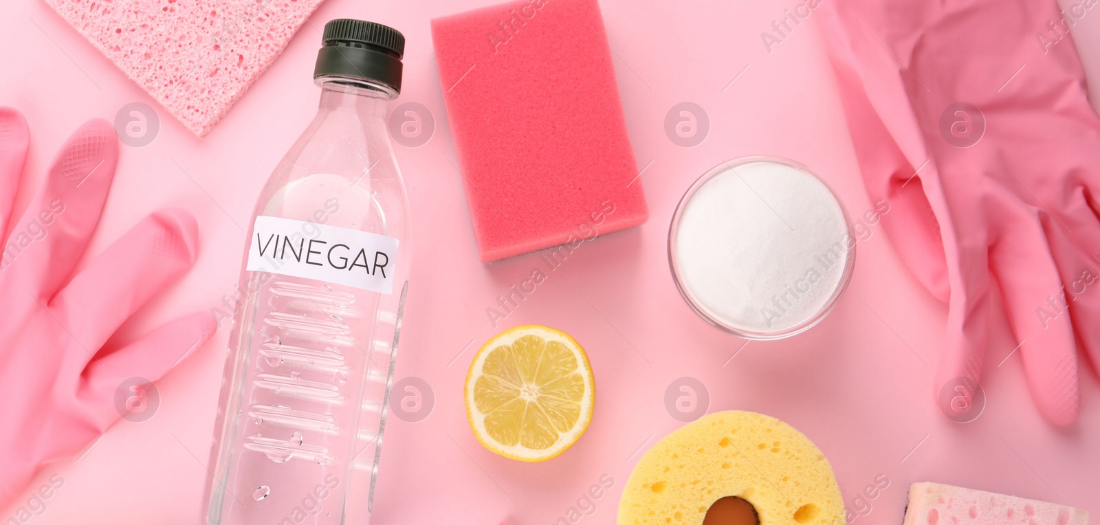 Photo of Eco friendly natural cleaners. Flat lay composition with bottle of vinegar on pink background