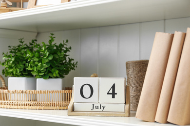 Photo of White shelving unit with calendar and decorative elements