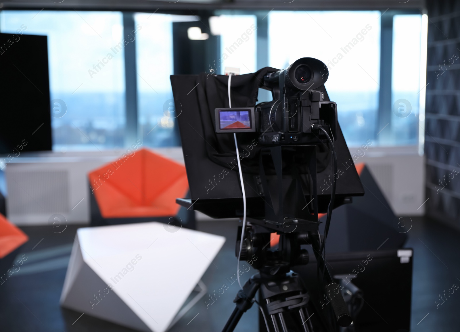 Photo of Modern video recording studio with professional equipment, focus on camera