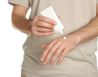 Photo of Man applying cream onto hand against white background, closeup