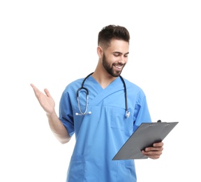 Photo of Young male doctor in uniform with clipboard isolated on white