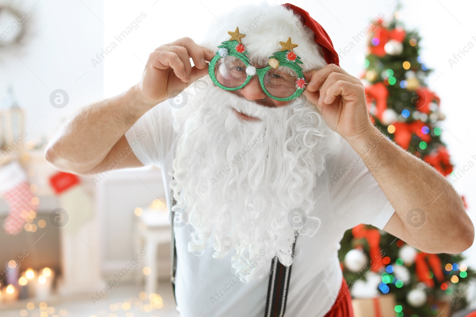 Photo of Authentic Santa Claus with funny glasses indoors