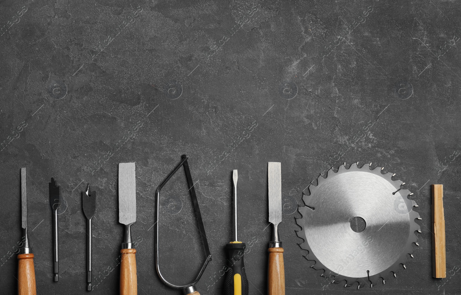 Photo of Flat lay composition with carpenter's tools on grey background. Space for text