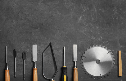 Photo of Flat lay composition with carpenter's tools on grey background. Space for text