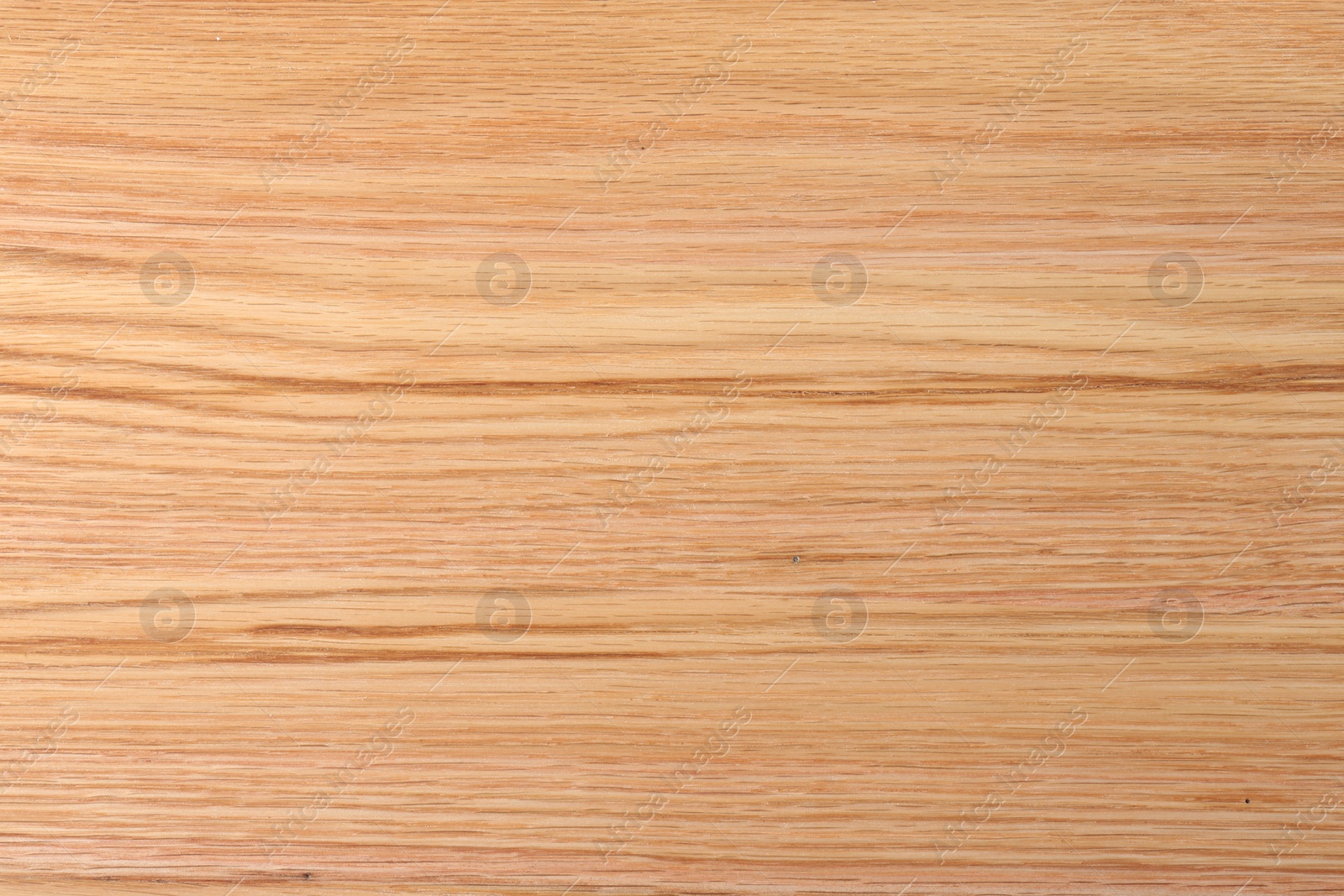 Photo of Texture of wooden cutting board as background, top view