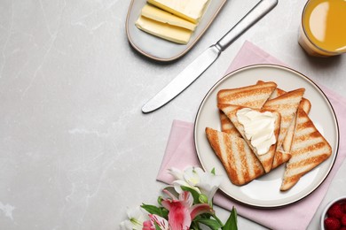Photo of Tasty toasts served with spreading butter and honey on light grey marble table, flat lay. Space for text