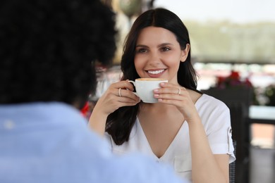 International dating. Lovely couple enjoying tasty coffee in cafe