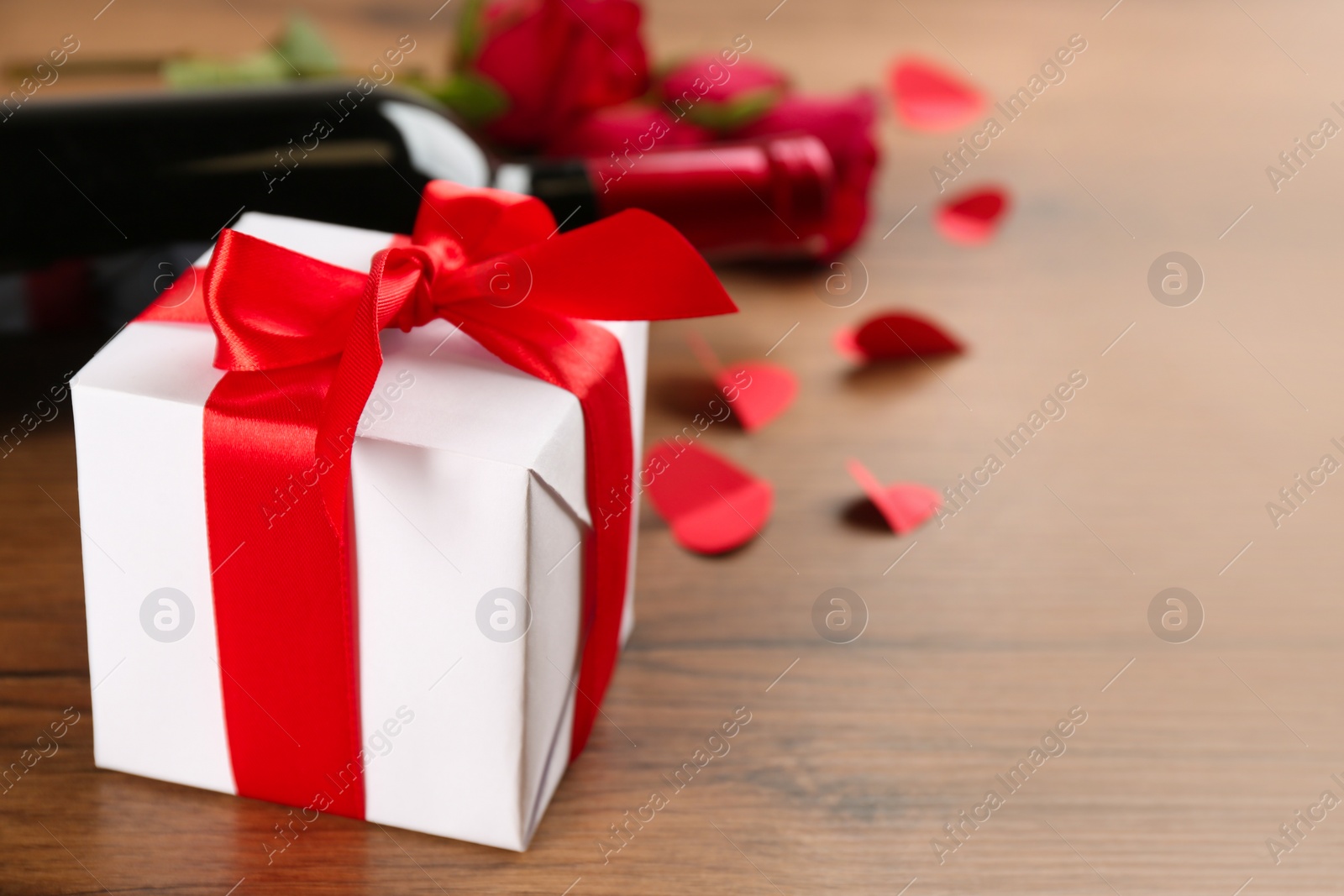 Photo of Beautiful gift box on wooden table, space for text. Valentine's Day celebration